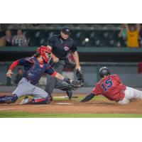 Kansas City Monarchs' Gabby Guerrero slides in ahead of the tag of Cleburne catcher John Nester