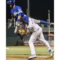 New York Boulders' 3B Tucker Nathans holds on to ball after tagging out a colliding Jonathan Lacroix of Equipe Quebec