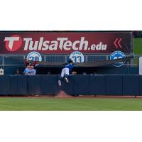 Tulsa Drillers centerfielder James Outman, goes airborne to try to take a home run away from Springfield's Matt Koperniak