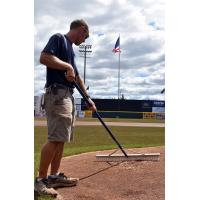 Somerset Patriots Head Groundskeeper Dan Purner works on the field the day after the flooding