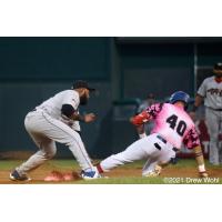 New York Boulders' Ray Hernandez slides safely into second base with a double under the tag of Tri-City SS Juan Silverio