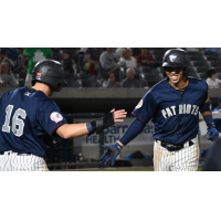 Somerset Patriots exchange congratulations after a run