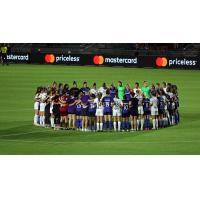 Racing Louisville FC and North Carolina Courage gather at midfield