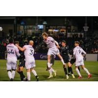 Forward Madison FC defender Connor Tobin goes high vs. Union Omaha