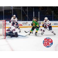 Swift Current Broncos left wing Brady Birnie (center) vs. the Regina Pats
