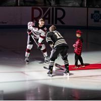 Muskegon Lumberjacks in the ceremonial faceoff circle with the Chicago Steel