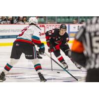 Prince George Cougars left wing Jonny Hooker (right) vs. the Kelowna Rockets