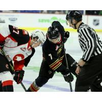 Vancouver Giants centre Ty Thorpe (right) faces off with the Prince George Cougars