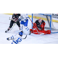 Cam Clarke of the Wichita Thunder (bottom) takes a shot against the Rapid City Rush