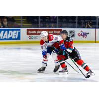Kelowna Rockets defenseman Elias Carmichael (right) vs. the Spokane Chiefs