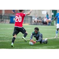 FC Edmonton goalkeeper Darlington Murasiranwa jumps on a loose ball