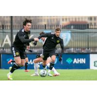 Wyatt Borso (left) and Russell Cicerone (center, on ball) of Pittsburgh Riverhounds SC vs. Villanova University