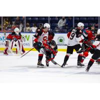 Kelowna Rockets left wing Gabriel Szturc (center) vs. the Prince George Cougars