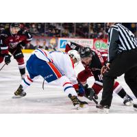 Vancouver Giants left wing Zack Ostapchuk (right) faces off with the Spokane Chiefs