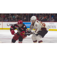 Cleveland Monsters center Jake Gaudet (right) vs. the Grand Rapids Griffins