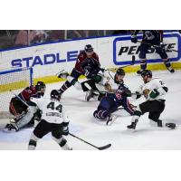Utah Grizzlies forward Tyler Penner (far right) launches a shot against the Tulsa Oilers