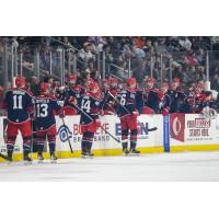 Allen Americans exchange high fives along the bench
