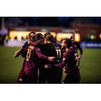 Detroit City FC huddles after a goal
