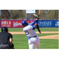 Nick Plummer of the Syracuse Mets swings and watches his go-ahead home run go over the right-field wall