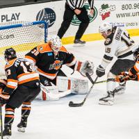 Wheeling Nailers forward Shaw Boomhower with the puck in front of the Fort Wayne Komets goal