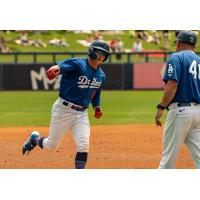 Ryan Ward of the Tulsa Drillers gets congratulations from manager Scott Hennessey for his third-inning home run