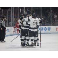 Quinn Hutson and the Muskegon Lumberjacks huddle after a goal
