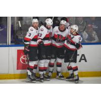 Belleville Senators gather after a goal