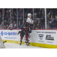 Ethan Semeniuk of the Vancouver Giants takes out Kaden Hammell of the Kamloops Blazers on the forecheck