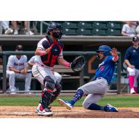 Michael Busch slides safely into homeplate for the Tulsa Drillers