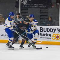 Knoxville Ice Bears' Razmuz Waxin-Engback battles Roanoke Rail Yard Dawg's Brady Heppner and Brendan Pepe