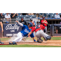 Jonny DeLuca of the Tulsa Drillers slides safely into home