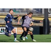 Robbie Mertz of the Pittsburgh Riverhounds dribbles away from Indy Eleven defenders