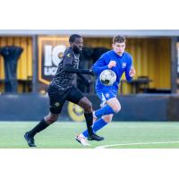 Pittsburgh Riverhounds SC captain Kenardo Forbes (left) vs. the University of Pittsburgh