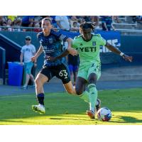 Emmanuel Johnson (right) holds off a San Jose player while controlling the ball last season for Austin FC II