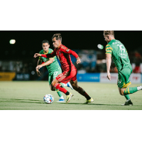 Phoenix Rising FC's Dariusz Formella versus Tampa Bay Rowdies' Danny Crisostomo and Danny Crisostomo