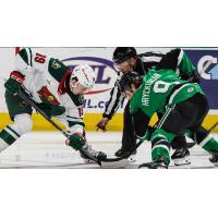 Texas Stars forward Justin Hryckowian (right) faces off with the Iowa Wild