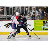Wenatchee Wild defenseman Brendan Dunphy holds off a Spokane Chiefs player