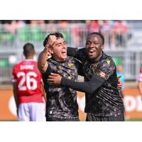 David Rodríguez (left) and Ballou Tabla celebrate an Atlético Ottawa goal