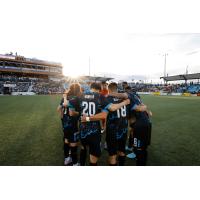 Colorado Springs Switchbacks FC's Yosuke Hanya and Aidan Rocha huddle with team