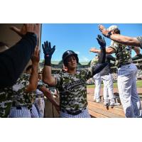 Somerset Patriots catcher Rafael Flores receives congratulations in the dugout