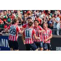 Atlético Ottawa gathers after a goal