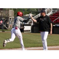 Sioux City Explorers Manager Steve Montgomery congratulates Abdeal Layer after his home run
