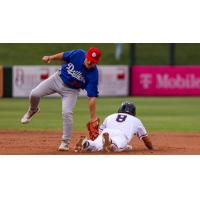 Taylor Young of the Tulsa Drillers attempts to tag out a Wichita base runner