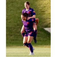 Calgary Wild FC celebrate a Taegan Stewart (top) goal