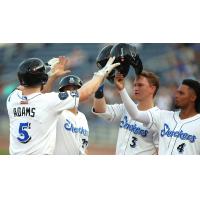 Biloxi Shuckers congratulate Luke Adams after his home