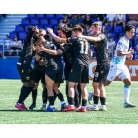 Atlético Ottawa players celebrate Ballou Tabla's opener