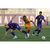 Rhode Island FC midfielder Zachary Herivaux eyes the ball vs. Louisville City FC