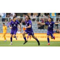 Louisville City FC defender Aiden McFadden (center) reacts after his goal