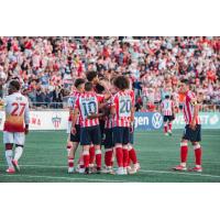 Atlético Ottawa gather following a goal