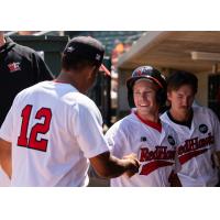 Fargo-Moorhead RedHawks exchange congratulations in the dugout